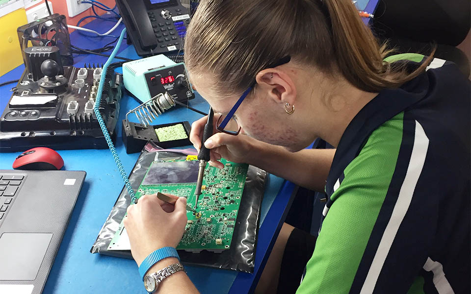 BMS Lasersat team member repairing equipment