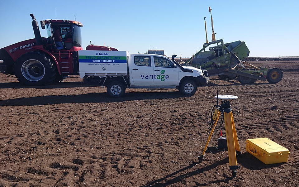 Vantage NEA vehicle in front of machinery and Trimble system in the field