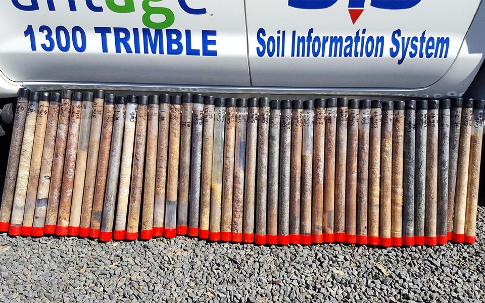 Tubes of soil for testing in front of Vantage vehicle